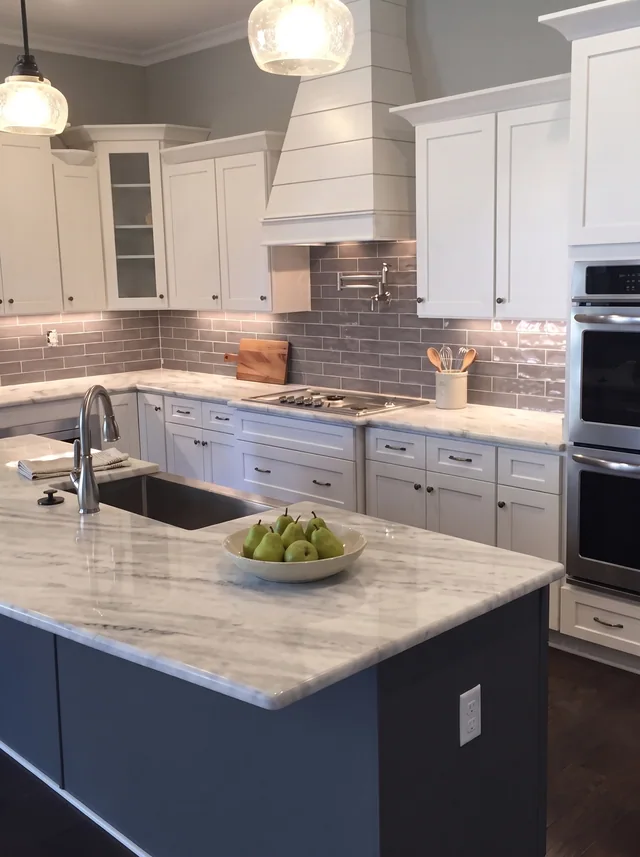 A blue island faces white cabinetry and a dark backsplash.
