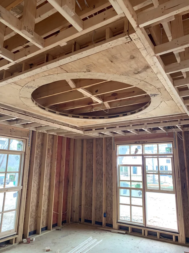 Circular ceiling framing within exposed joists, with temporary access equipment removed.