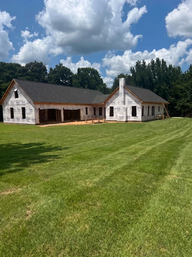 A broad gabled home and long porch.