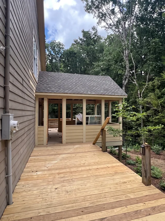 A timber deck leads to a covered porch.